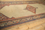 Antique Serab runner at an angle, with its seeded lattice field and intricate geometric borders.
