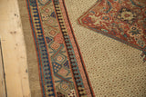 Corner detail of an antique Serab with its seeded lattice field and intricate pawn design border.