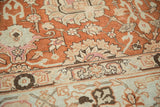 Detail of the distressed low pile with terracotta palmettes and pale blue floral vinery.