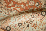 A fold in the vintage Tabriz carpet contrasts terracotta palmettes with ivory floral details.