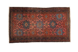 Vintage Mehriban rug with staggered hook-and-latch medallions in raspberry red and dusty teal blue.