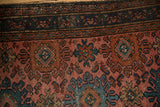 Vintage Mehriban rug with ribboned border of meandering vines and pale raspberry field motifs.