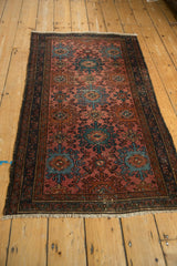 Close-up of vintage Mehriban rug side border with navy vines, dusty teal medallions.