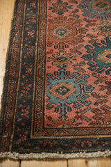 Mehriban rug corner, pale raspberry field, ribboned borders, and teal medallions.