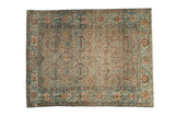 Vintage distressed Malayer rug with geometric cartouches in dusty teal and copper over a sandy beige field.