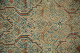 Interconnected geometric vines and floral motifs on the evenly worn pile of a Persian rug.