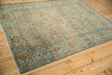 Angled view of the vintage distressed Malayer rug's interconnected geometric patterns.