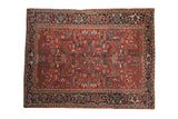 Vintage Heriz carpet with a red geometric field of serrated leaves and a navy blue Turtle Samovar border.