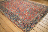 Angled view of a Persian Heriz rug's geometric motifs and Turtle Samovar design border.