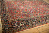 Angled corner view of a vintage Heriz carpet showing the complex Turtle Samovar border.
