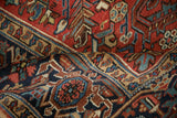 Intricate Turtle Samovar border in navy, red, and dusty teal on a hand-knotted Heriz carpet.