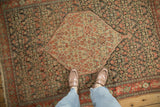 Ivory hexagonal medallion contrasting with the dark Herati field of an antique Senneh rug.