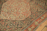Corner view contrasting the ivory medallion, charcoal Herati field, and restored red border.