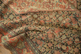 Low pile of an antique Senneh rug with an articulated Herati design and time-softened colors.