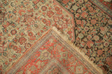 Herati pattern detail in fuchsia and sky blue on an antique Senneh's contrasting ivory and charcoal fields.