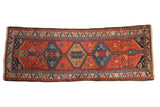 Vintage Kurdish Hamadan runner with triple oversized serrated medallions in brick red, dusty teal, and navy blue.