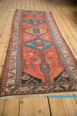 Angled view of a vintage Kurdish runner highlighting its repeating serrated medallions.