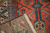Folded corner of a vintage Kurdish runner showing the hand-knotted weave and foundation.