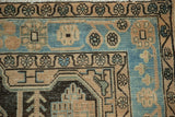 Geometric floral border on a vintage Hamadan rug corner in sky blue, sand, and dark brown.