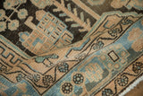 A stylized bird motif in sandy beige and sky blue on a vintage Persian Hamadan rug.