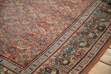 Brick red Herati patterned field meeting dusty beige germinating plant motif border.