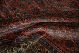 Textured Herati pattern in brick red and dusty blue on a vintage Bijar carpet.