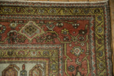 Distressed Hamadan carpet corner, showcasing dusty terracotta, olive, and silver Samovar border.