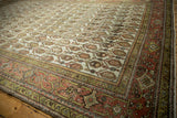 Corner of distressed Hamadan rug, featuring terracotta Samovar border with double vine and worn field.