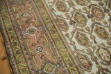 Distressed Hamadan carpet close-up: dusty terracotta border, green vine, platinum field, gold botehs.