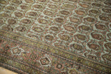 Distressed vintage Hamadan carpet detail: meandering vine border, boteh field, worn pile.