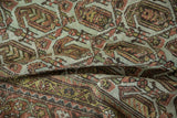 Worn, textured pile of a distressed Hamadan rug in muted terracotta, brown, and sage.