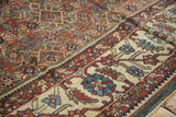 Detail of a distressed Mahal's worn texture, showing the dark Herati field meeting the wide ivory border.