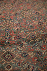 Angled view across the low, even pile of a distressed Mahal showing its Herati motif.