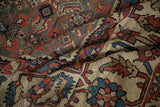 Folds revealing the time-softened texture and Herati patterns on a vintage Mahal carpet.
