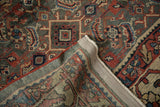 Corner of a distressed Persian Mahal carpet folded to show the woven foundation and secured side cord.