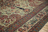 Intricate curvilinear design and rich color palette of a late 19th-century Persian Kerman carpet.