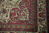 Exquisitely drawn corner of a fine antique Kerman with scrolling red and blue arabesques.