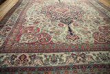 A low-angle view across the antique Kerman rug, showing its finely woven texture.