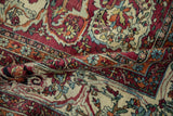 Exquisitely drawn arabesques on the folded, finely woven pile of an antique Kerman carpet.