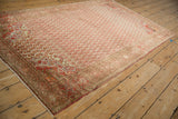 Pomegranate corner spandrel with tangerine and blush tones on a vintage distressed Malayer rug.