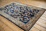 Angled view of a vintage Sarouk rug highlighting the high gloss sheen of its floral pile.
