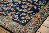 Angled corner view of a vintage Sarouk rug highlighting its lustrous wool pile and floral border.