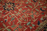 Cherry red field of Heriz carpet showing interconnected blue vines and geometric blossoms.