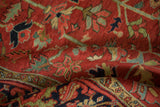 Vintage Heriz rug pile: cherry red geometric blossoms and navy blue Turtle Samovar border.
