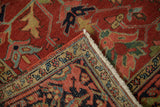 Vintage Heriz rug corner with cherry red field, green vines, and reciprocating Turtle Samovar border.