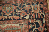 Traditional Serapi carpet's navy field with brick red arabesques and floral border.