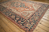 Antique Serapi carpet: navy main border, brick red field, multi-stemmed vines.