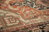 Close-up of antique Serapi carpet border: brick red interconnected floral vines, dusty blush.