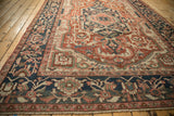 Navy blue main border of the antique Serapi carpet with floral vines and fringe.