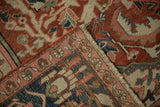 Antique Serapi carpet detail: brick red field pattern, navy border, and preserved side selvage.